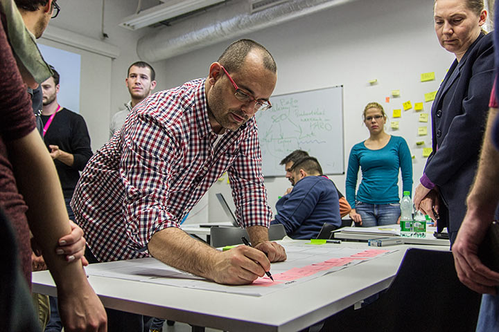 Marko Dugonjic mapping a user flow during a UX for Startups workshop at Hub:Raum in Krakow, Poland.